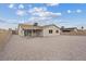 Gravel backyard with a covered patio and block fence at 7181 Pleasant View Ave, Las Vegas, NV 89147