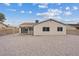 Spacious gravel backyard with covered patio and block wall at 7181 Pleasant View Ave, Las Vegas, NV 89147