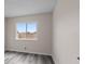 Bedroom featuring gray floors and a large window at 7181 Pleasant View Ave, Las Vegas, NV 89147