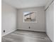 Cozy bedroom features gray wood-look flooring, a window, and a closet at 7181 Pleasant View Ave, Las Vegas, NV 89147
