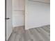 Bright bedroom features gray wood-look flooring and built-in closet storage space at 7181 Pleasant View Ave, Las Vegas, NV 89147