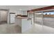 Open kitchen with white cabinetry, island, and a sliding door to the outside at 7181 Pleasant View Ave, Las Vegas, NV 89147