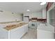 Spacious kitchen features white cabinetry, stainless steel appliances, and brick accent wall at 7181 Pleasant View Ave, Las Vegas, NV 89147
