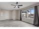 Bright living room with sleek floors, a fan, and a large window at 7181 Pleasant View Ave, Las Vegas, NV 89147