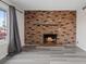 Comfortable living room with a brick fireplace and large window at 7181 Pleasant View Ave, Las Vegas, NV 89147