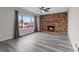 Cozy living room featuring a brick fireplace and modern flooring at 7181 Pleasant View Ave, Las Vegas, NV 89147