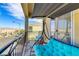 Balcony with a comfortable swing, ideal for relaxation and enjoying the neighborhood view at 7609 Trimming Ct, Las Vegas, NV 89149