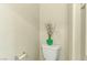 Neutral bathroom with a toilet, decorative vase, and roll holder at 7609 Trimming Ct, Las Vegas, NV 89149