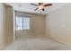 Bright and spacious bedroom with a ceiling fan and carpeted floor at 7609 Trimming Ct, Las Vegas, NV 89149