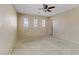 Spacious bedroom featuring a ceiling fan, carpeted floors, and ample natural light at 7609 Trimming Ct, Las Vegas, NV 89149