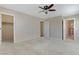 Neutral bedroom with a ceiling fan and doorways to the closet and bathroom at 7609 Trimming Ct, Las Vegas, NV 89149