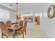 Charming dining area with a decorative table and chairs with views into a modern kitchen at 7609 Trimming Ct, Las Vegas, NV 89149