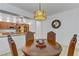 Dining area featuring a wooden table with upholstered chairs and stylish hanging light at 7609 Trimming Ct, Las Vegas, NV 89149