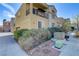 Charming exterior view featuring a balcony, well-maintained landscaping, and a side entryway at 7609 Trimming Ct, Las Vegas, NV 89149