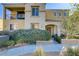 Inviting home featuring a charming front entrance with a well-manicured landscape and cozy second story balcony at 7609 Trimming Ct, Las Vegas, NV 89149