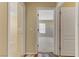 Hallway with neutral walls, wood-look tile flooring, and open doorways at 7609 Trimming Ct, Las Vegas, NV 89149