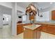 Open-concept kitchen with granite countertops, island, stainless steel sink, and stylish cabinetry at 7609 Trimming Ct, Las Vegas, NV 89149