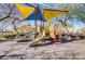 Community playground with colorful slides, ladders, and shaded play areas at 7609 Trimming Ct, Las Vegas, NV 89149