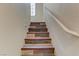 Stairway with modern wood-like tile design and a light-colored handrail at 7609 Trimming Ct, Las Vegas, NV 89149