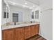 Bathroom vanity with double sinks, granite countertop and wood cabinets offers plenty of space at 7722 Top Hat Ave, Las Vegas, NV 89113