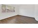 Bright bedroom with wood-look flooring, large window, and neutral walls, offering a clean and versatile space at 7722 Top Hat Ave, Las Vegas, NV 89113