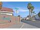 The Spanish Bay community entrance with desert landscaping and palm trees under a clear, sunny sky at 7722 Top Hat Ave, Las Vegas, NV 89113