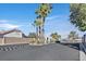 Community entrance with manicured landscaping and gated access at 7722 Top Hat Ave, Las Vegas, NV 89113
