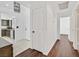 Hallway with hardwood floors and tile floors provides easy access to kitchen and rooms at 7722 Top Hat Ave, Las Vegas, NV 89113