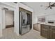 Kitchen with stainless steel refrigerator and dark wood cabinets at 7722 Top Hat Ave, Las Vegas, NV 89113