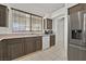 Well-lit kitchen with ample counter space, stainless steel refrigerator and modern appliances at 7722 Top Hat Ave, Las Vegas, NV 89113