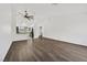 Open-concept living room and kitchen area features hardwood floors and a ceiling fan at 7722 Top Hat Ave, Las Vegas, NV 89113