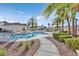 Community pool with palm trees and lounge chairs for residents at 7722 Top Hat Ave, Las Vegas, NV 89113