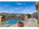 Balcony overlooking a community pool, framed by a decorative railing and offering a serene outdoor living space at 8093 Luna Sera Ave, Las Vegas, NV 89178
