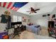 Bedroom with a ceiling fan, desk, and bed with an American flag at 8093 Luna Sera Ave, Las Vegas, NV 89178
