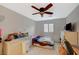 Bedroom with ceiling fan, bed, desk, and window with natural light at 8093 Luna Sera Ave, Las Vegas, NV 89178