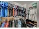 Well-organized walk-in closet with an extensive collection of clothes arranged neatly on racks and shelves at 8093 Luna Sera Ave, Las Vegas, NV 89178