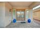 Elegant front entrance with double doors, sidelight windows, and blue decorative urns at 8093 Luna Sera Ave, Las Vegas, NV 89178
