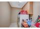 Dedicated laundry room equipped with a washer and dryer, overhead cabinets, and storage space at 8093 Luna Sera Ave, Las Vegas, NV 89178