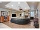 Stylish living room with a stone fireplace, tray ceiling, and sleek leather sectional at 8093 Luna Sera Ave, Las Vegas, NV 89178