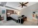 Spacious main bedroom with beam ceilings, fan, carpet, and ample natural light, creating a relaxing retreat at 8093 Luna Sera Ave, Las Vegas, NV 89178