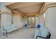Inviting covered patio featuring tiled flooring, seating, and decorative blue planters at the entrance at 8093 Luna Sera Ave, Las Vegas, NV 89178
