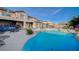 Backyard pool area featuring a swimming pool, tanning chairs, outdoor seating, and barbecue grill at 8093 Luna Sera Ave, Las Vegas, NV 89178