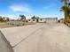 Single story house featuring a wide driveway, an attached garage, and mature palms at 810 Kenny Way, Las Vegas, NV 89107