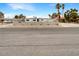 Street view of single story home, featuring xeriscaping and mature palm trees at 810 Kenny Way, Las Vegas, NV 89107