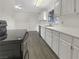 Bright kitchen features white cabinets, stainless steel appliances, and modern countertops at 810 Kenny Way, Las Vegas, NV 89107