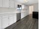 Modern kitchen with stainless steel appliances, white cabinets, and durable floor at 810 Kenny Way, Las Vegas, NV 89107