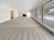 Spacious living room with carpet, fireplace, and large windows with backyard views at 810 Kenny Way, Las Vegas, NV 89107