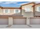 Townhomes featuring garages and charming architectural details at 8520 Insignia Ave # 104, Las Vegas, NV 89178