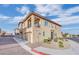 Townhome exterior featuring garage, balcony, and well-maintained landscaping at 8520 Insignia Ave # 104, Las Vegas, NV 89178