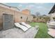 Serene backyard featuring artificial grass, lounge chairs, storage and a cozy swing at 8890 Bonneville Peak Ct, Las Vegas, NV 89148